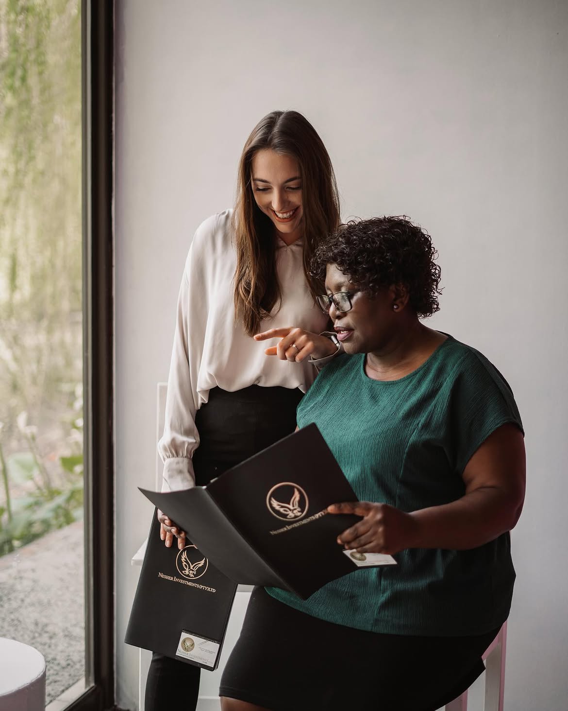 Nesher Investments advisors with a client
